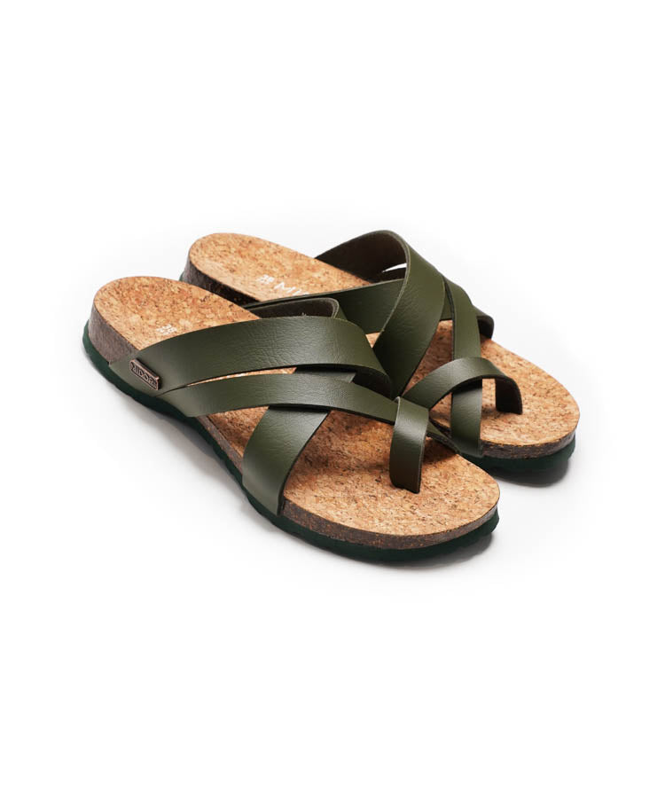 Pair of sandals with cork sole and green straps on a white background