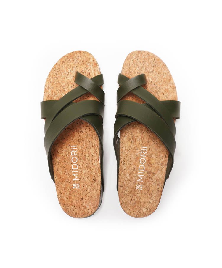 Pair of green sandals with cork soles on a white background